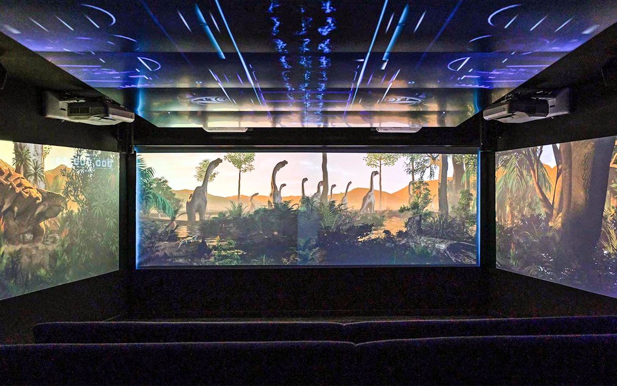 Underwater theatre showing dinosaurs on screen.