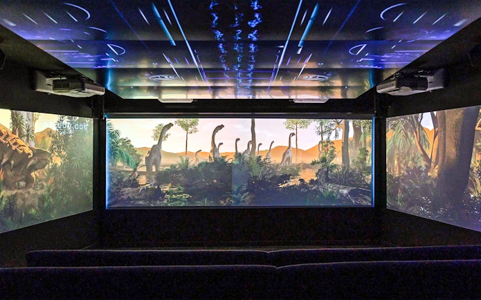 Underwater theatre showing dinosaurs on screen.