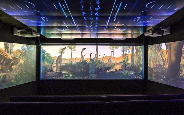Underwater theatre showing dinosaurs on screen.