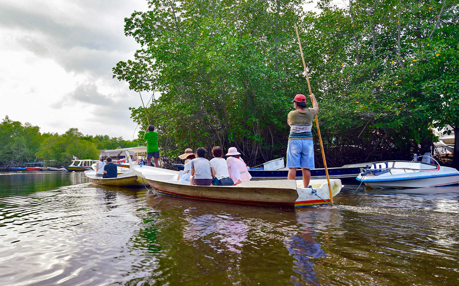 Boats navigating through mangroves on Nusa Lembongan snorkeling tour.