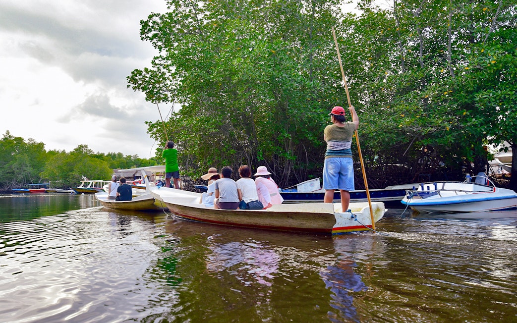 Boats navigating through mangroves on Nusa Lembongan snorkeling tour.