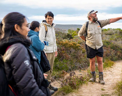 Tour guide leading group on Bruny Island nature trail, Hobart adventure tour.