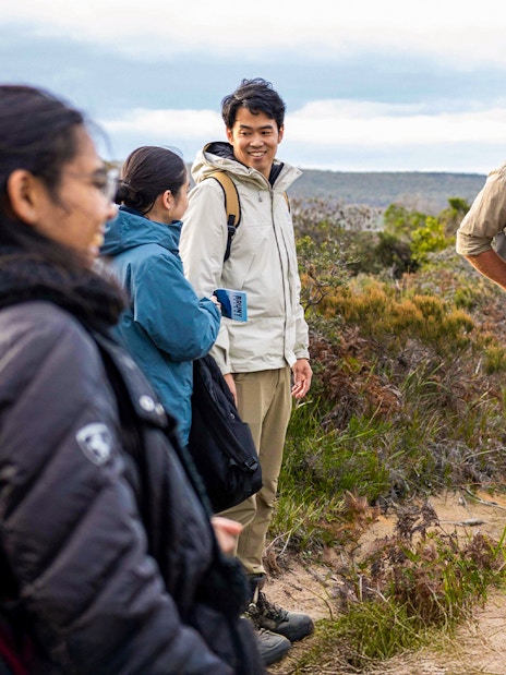 Tour guide leading group on Bruny Island nature trail, Hobart adventure tour.