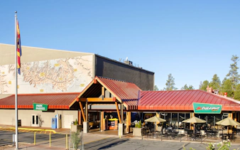 Grand Canyon IMAX theater entrance with map mural and outdoor seating area.