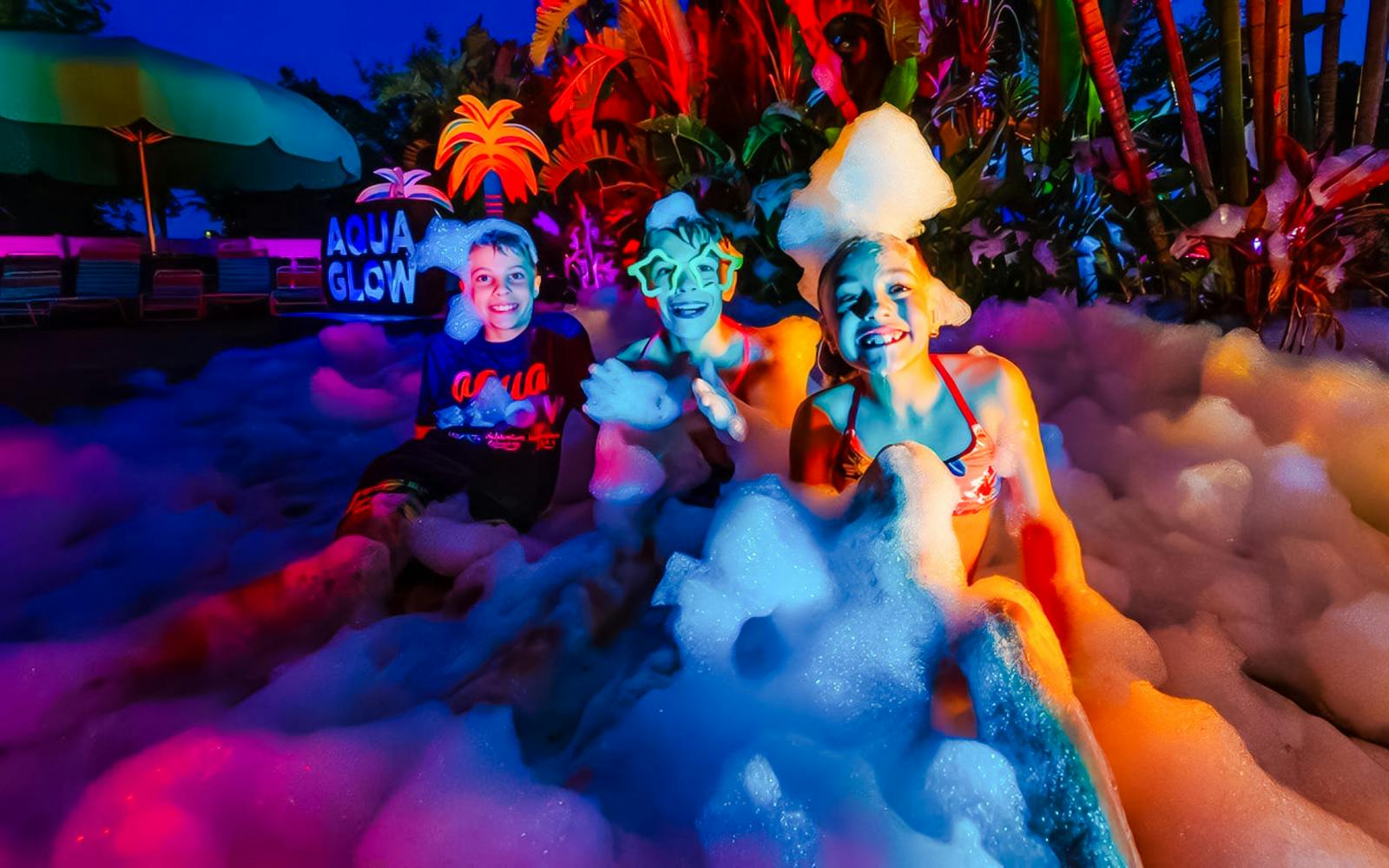 Children enjoying foam party at AquaGlow, Adventure Island Tampa.