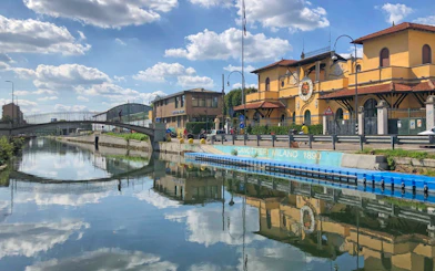 Navigli canal with bridge and historic building in Milan.