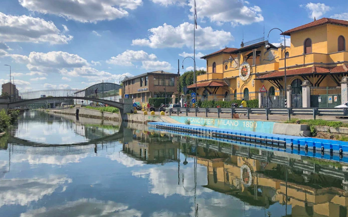 Navigli canal with bridge and historic building in Milan.