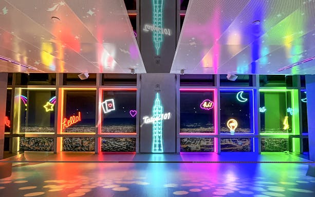 Neon-lit Taipei 101 Observatory interior with city view, Taiwan.