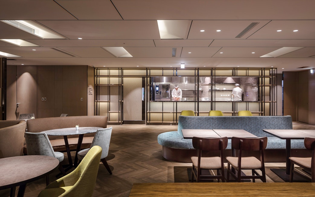 Plaza Premium Lounge seating area with chef in kitchen, Zone A, Taipei, Taiwan.