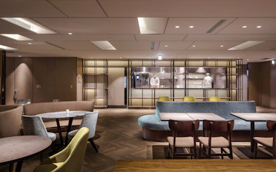 Plaza Premium Lounge seating area with chef in kitchen, Zone A, Taipei, Taiwan.