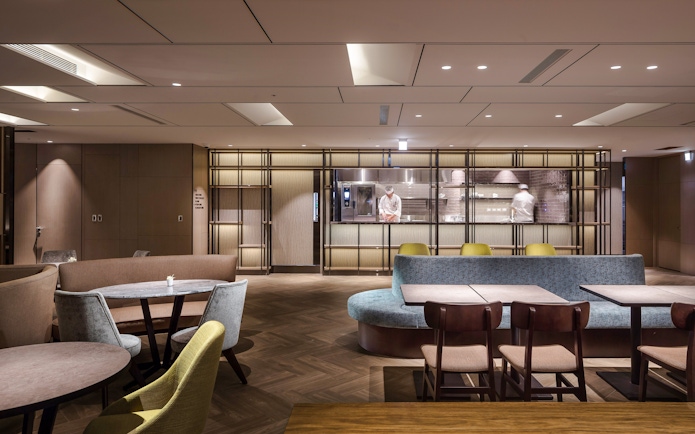 Plaza Premium Lounge seating area with chef in kitchen, Zone A, Taipei, Taiwan.