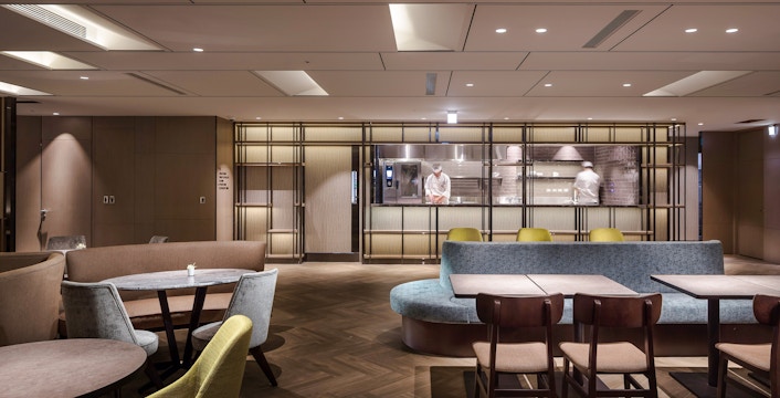 Plaza Premium Lounge seating area with chef in kitchen, Zone A, Taipei, Taiwan.