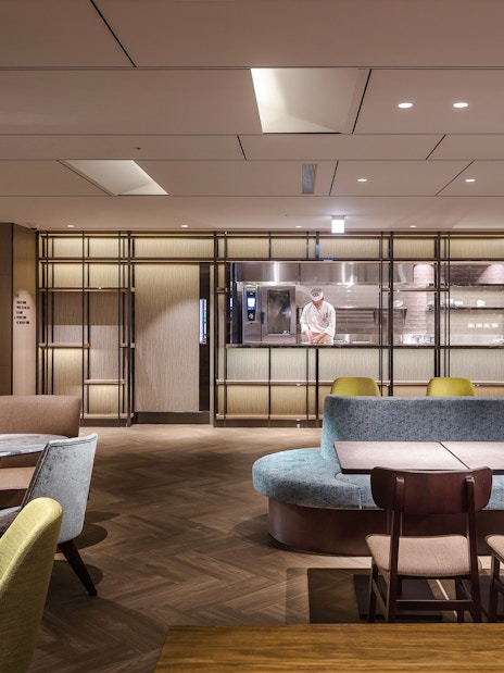 Plaza Premium Lounge seating area with chef in kitchen, Zone A, Taipei, Taiwan.