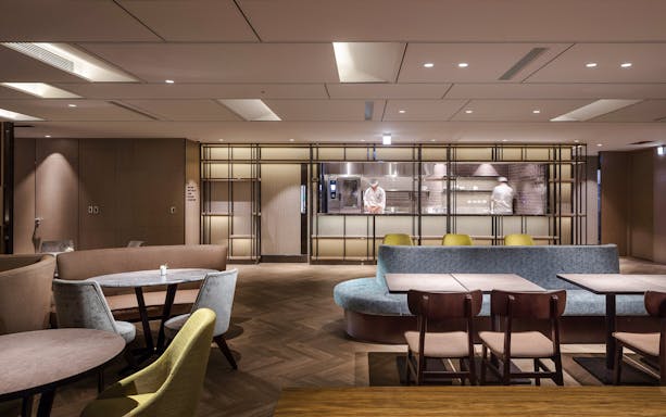 Plaza Premium Lounge seating area with chef in kitchen, Zone A, Taipei, Taiwan.