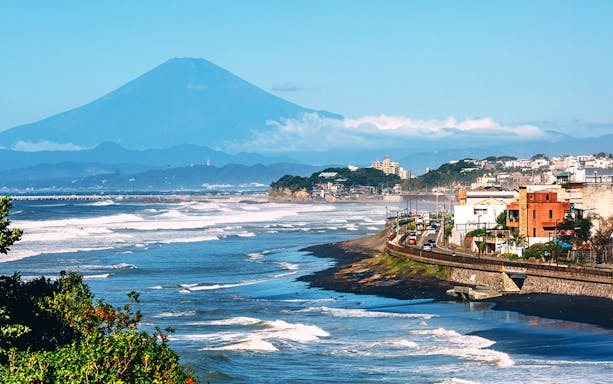 Coastal view of Enoshima Island with Mount Fuji in the background, Japan.