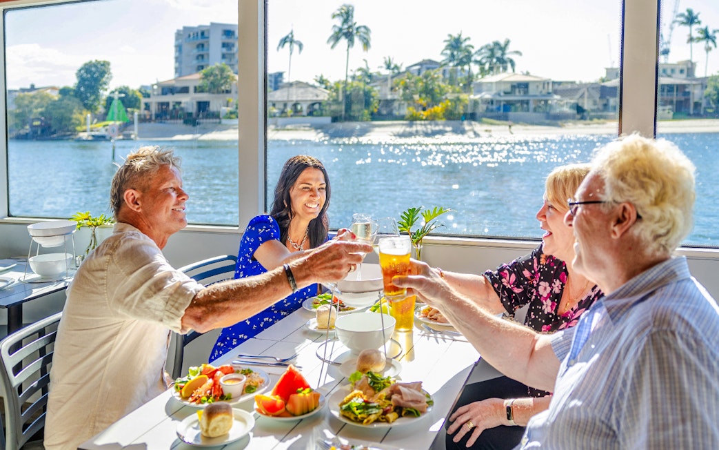 Four guests enjoying a buffet lunch on a vessel with Gold Coast views.