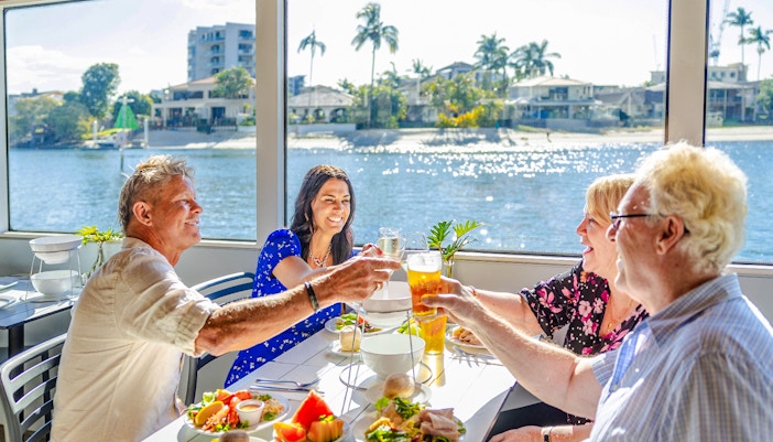 Four guests enjoying a buffet lunch on a vessel with Gold Coast views.