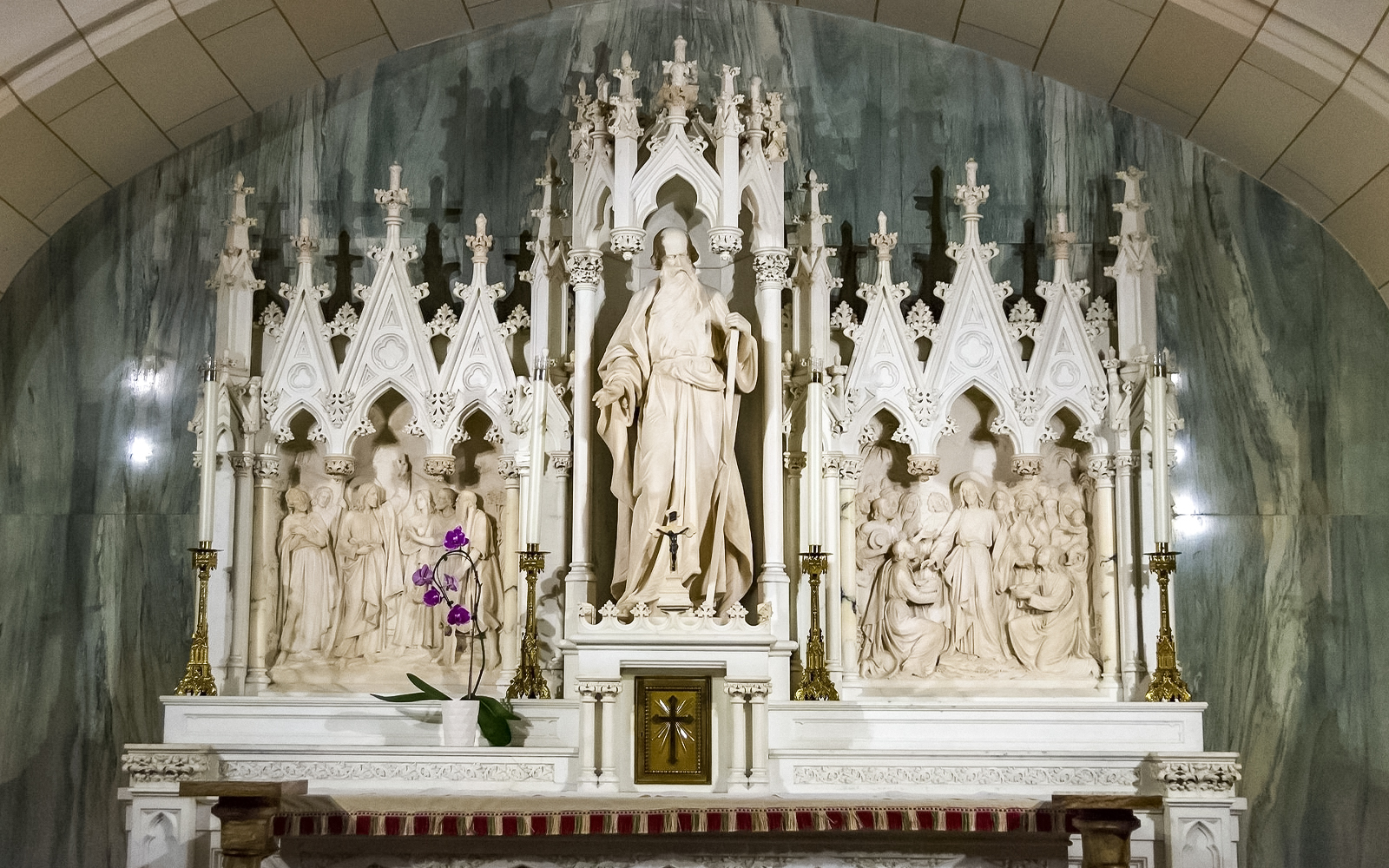 St. Patrick's Cathedral altar with intricate sculptures and floral decoration.