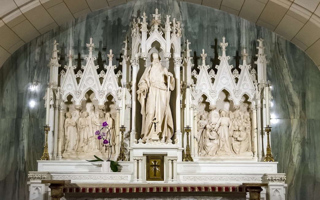 St. Patrick's Cathedral altar with intricate sculptures and floral decoration.