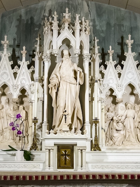 St. Patrick's Cathedral altar with intricate sculptures and floral decoration.