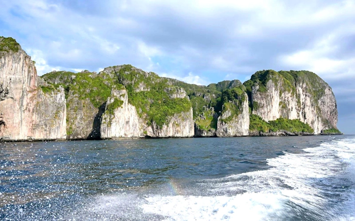 Phi Phi Islands limestone cliffs viewed from a speedboat, Phuket tour.