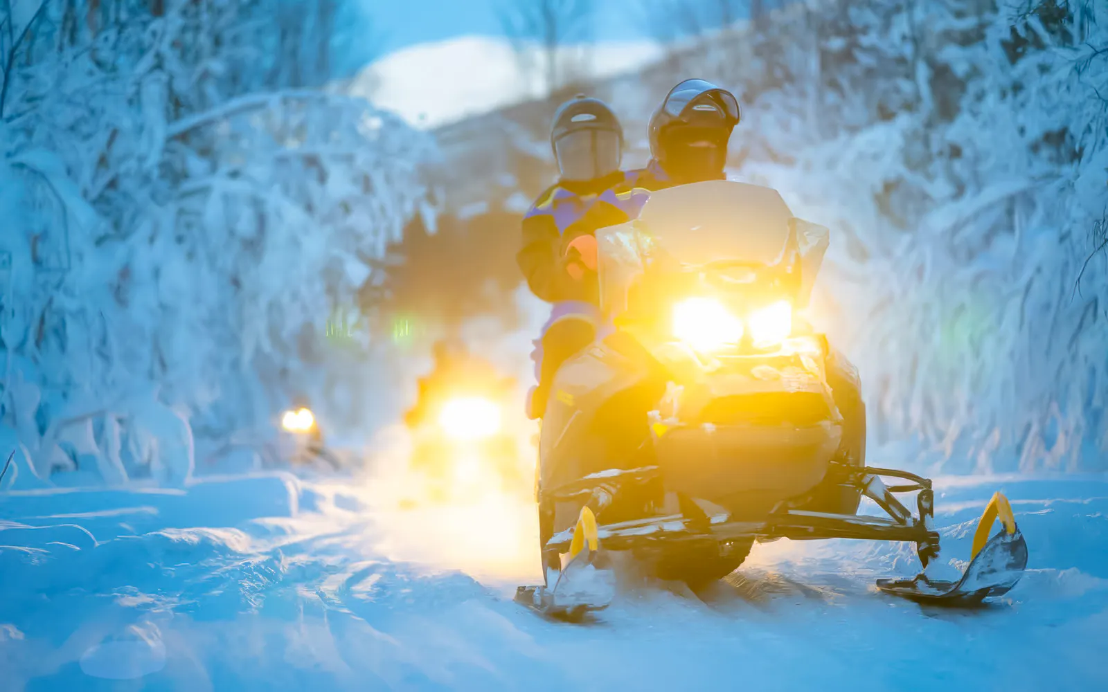 Snowmobiles on snowy trail during small-group day trip in Tromso.