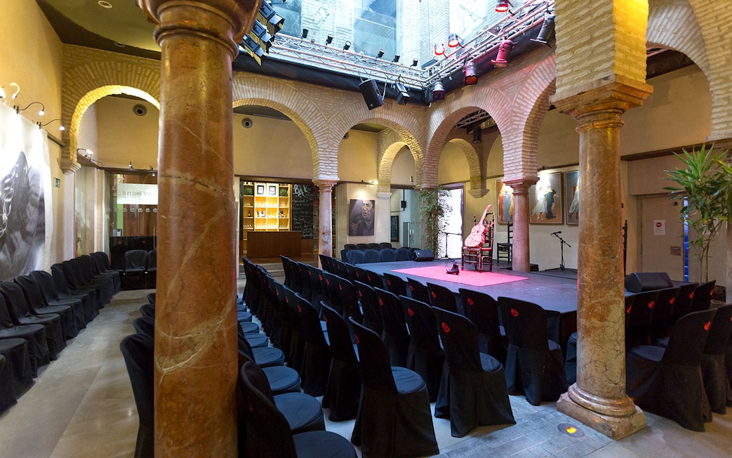 Flamenco Dance Museum stage set for a flamenco show with seating and arches.