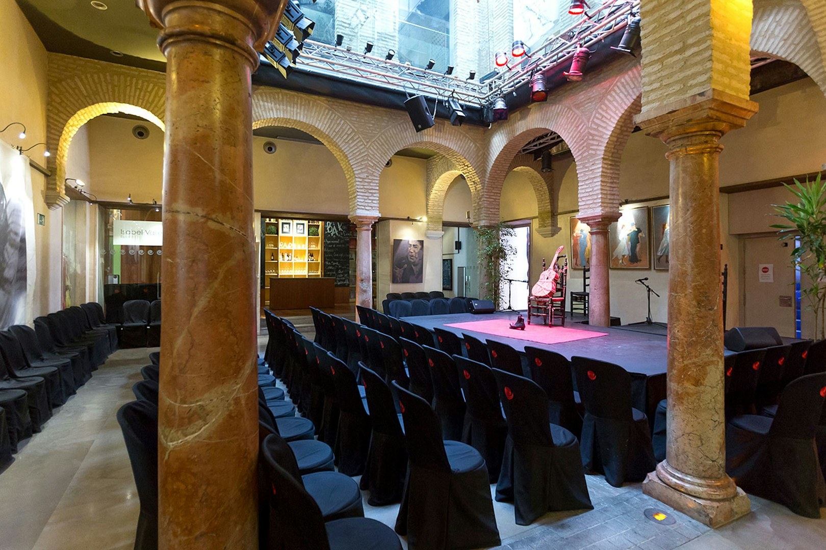 Flamenco Dance Museum stage set for a flamenco show with seating and arches.