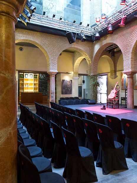 Flamenco Dance Museum stage set for a flamenco show with seating and arches.