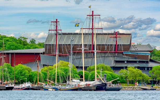 Vasa Museum in Stockholm with ships docked in front.