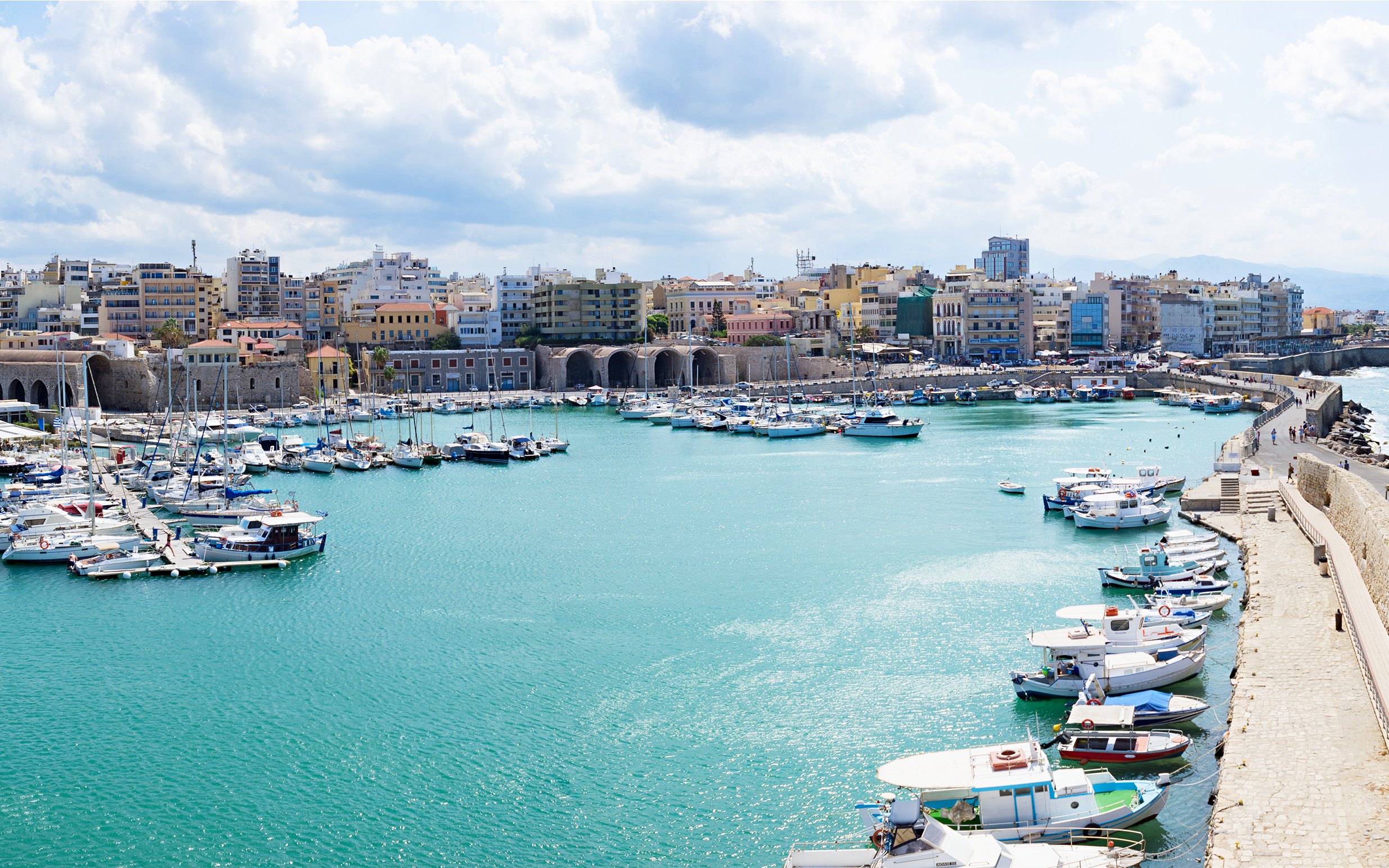 Heraklion marina with boats and historic city wall, Crete, Greece.