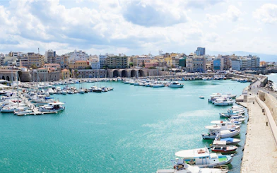 Heraklion marina with boats and historic city wall, Crete, Greece.