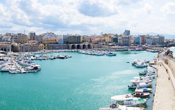 Heraklion marina with boats and historic city wall, Crete, Greece.