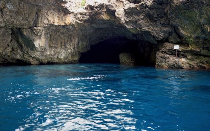 Cave entrance with blue water in Egadi, Sicily, Italy.