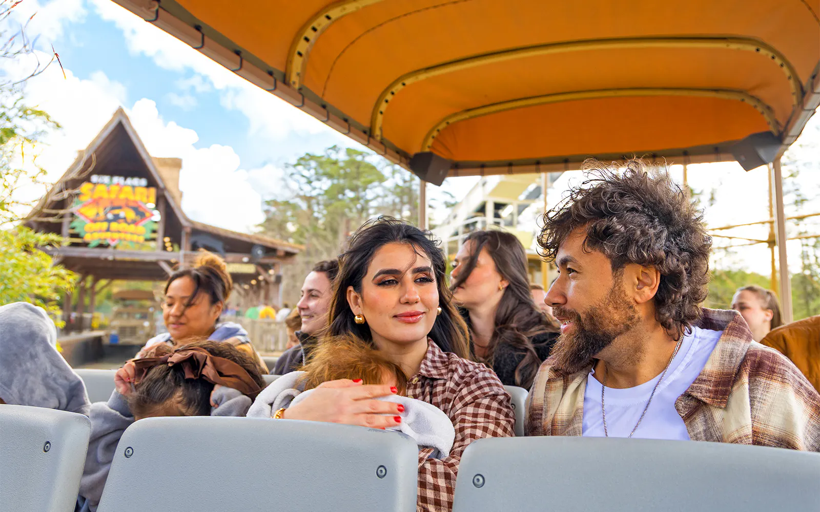 Visitors enjoying Six Flags Wild Safari Off-Road Adventure in an open-air vehicle.