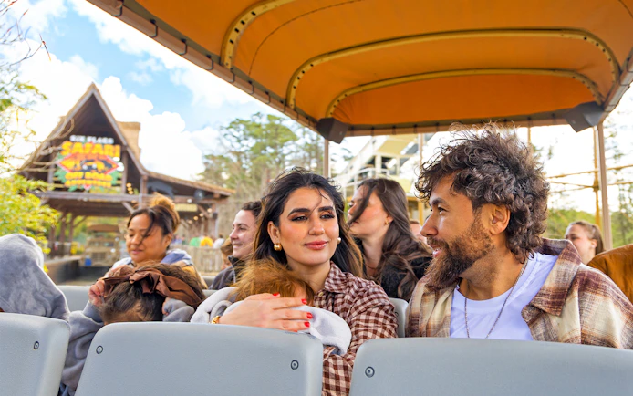 Visitors enjoying Six Flags Wild Safari Off-Road Adventure in an open-air vehicle.