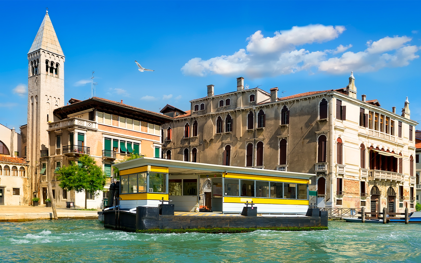 Valporetto stop in Venice with bright yellow signage.