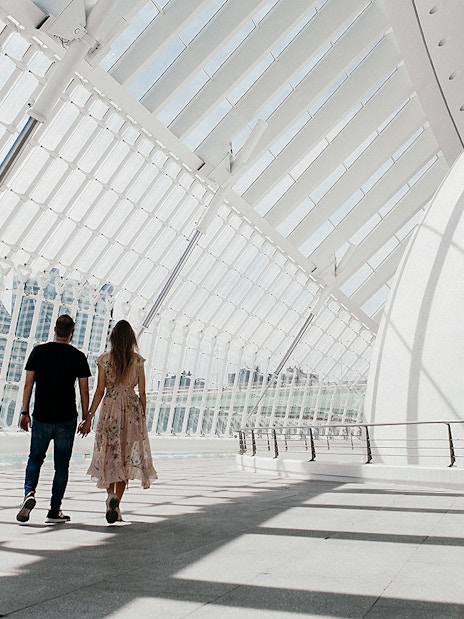 Couple walking inside Hemisfèric building, Valencia's City of Arts and Sciences.