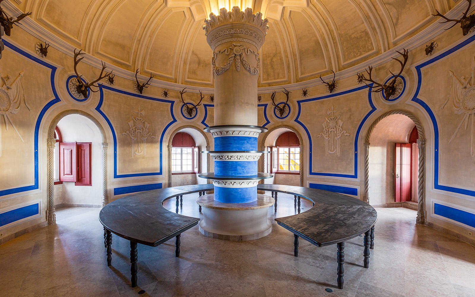 Interior of National Palace of Pena with ornate columns and antler decorations.