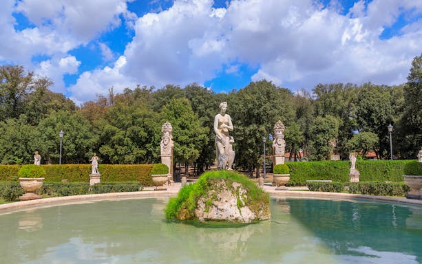Statue and fountain in Villa Borghese gardens, Rome, seen on golf cart tour.