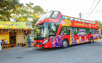 City Sightseeing Hue Hop-On Hop-Off bus near local market in Hue, Vietnam.
