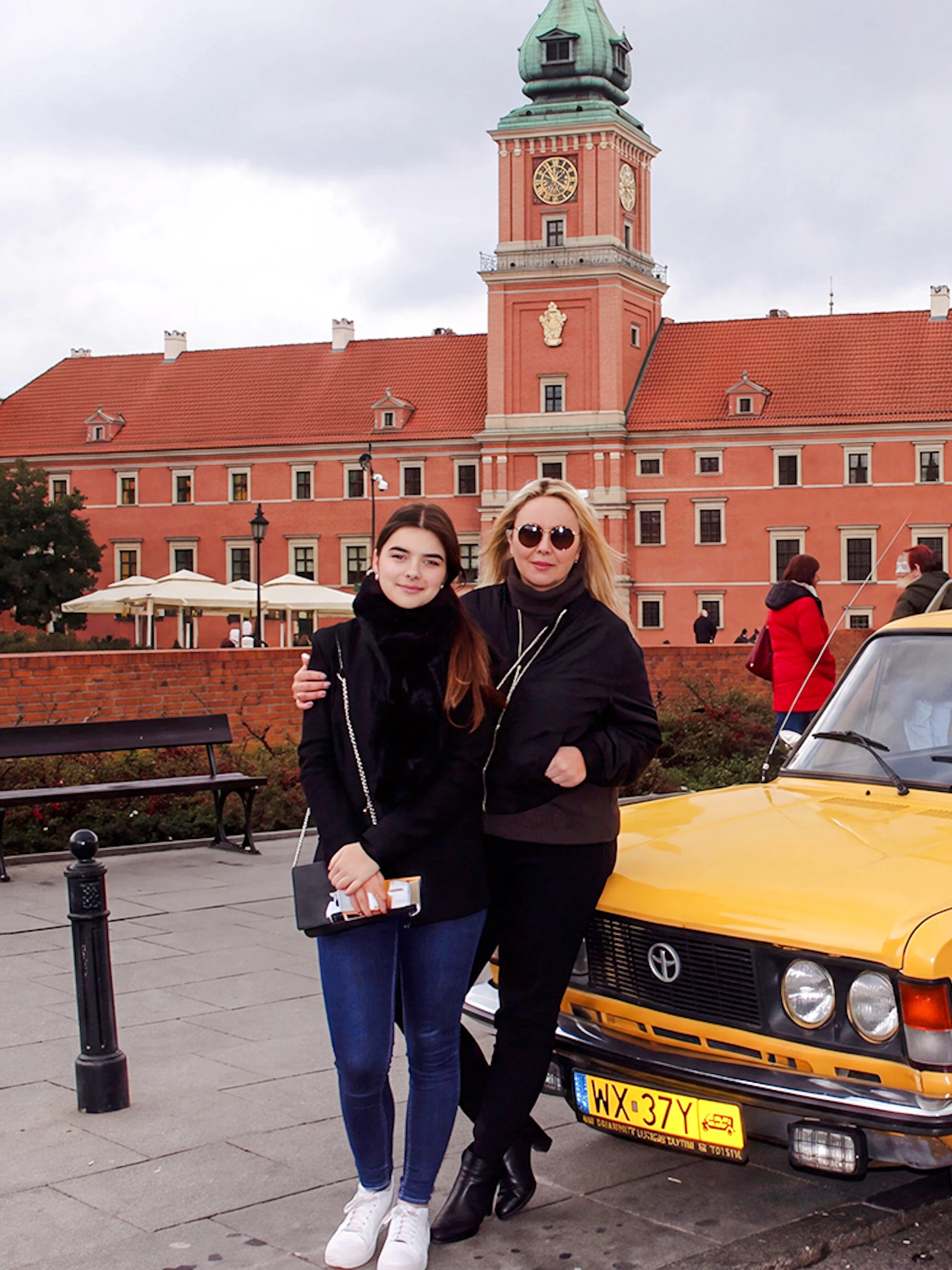 Yellow Fiat 125p in front of Warsaw's Royal Castle.