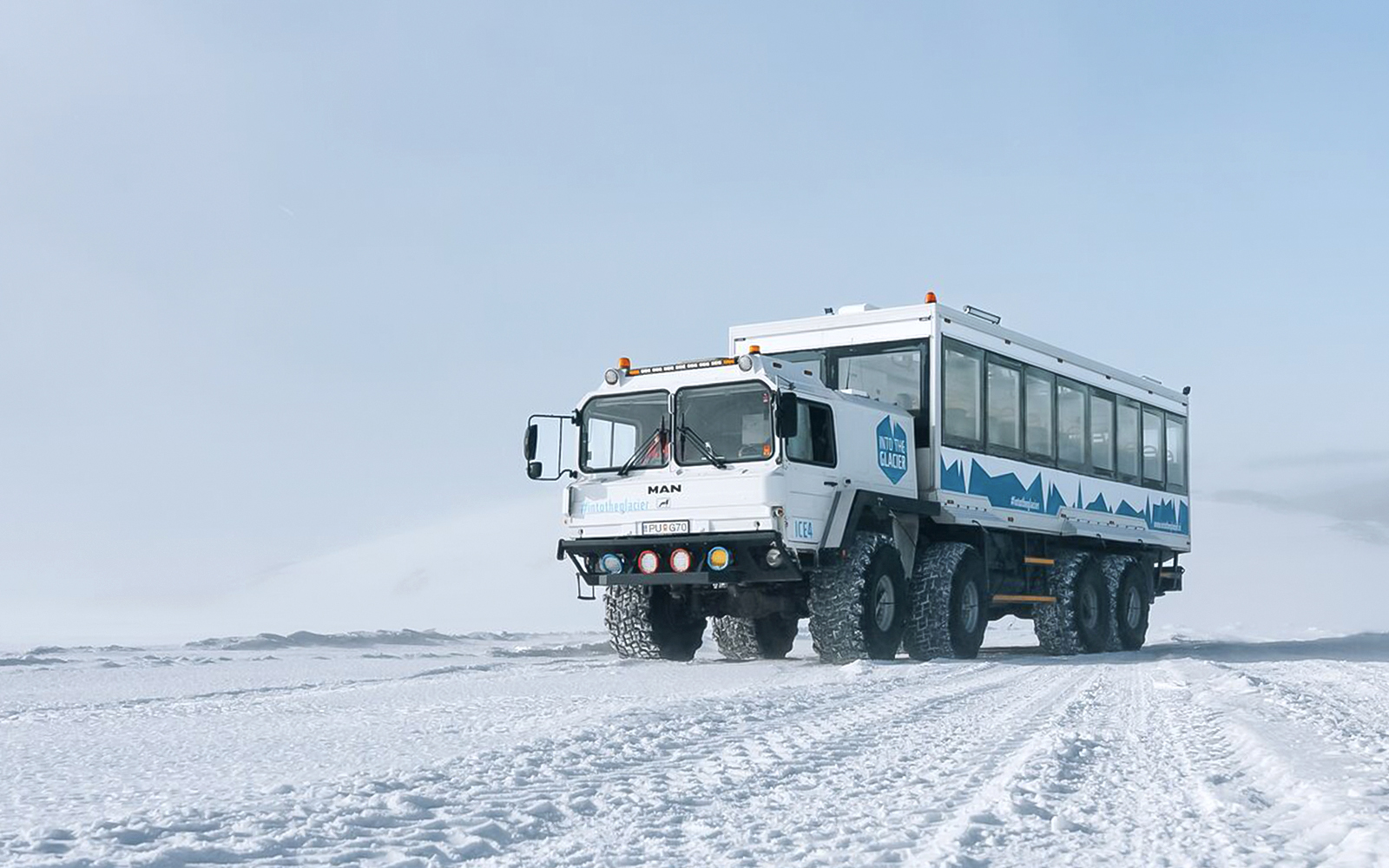 Snow truck on Langjökull glacier used for ice cave adventure tours.