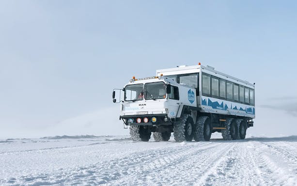Snow truck on Langjökull glacier used for ice cave adventure tours.