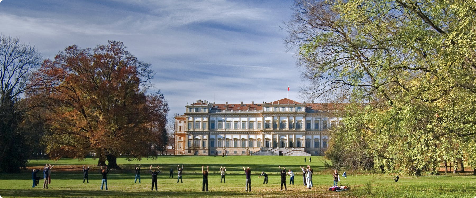 People practicing yoga in front of Villa Reale in Monza, Italy.