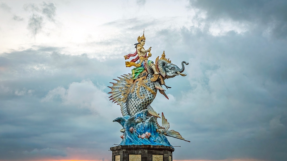 God Baruna statue in Pererenan beach at sunset, Bali, Indonesia