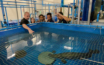 Visitors observing aquatic life at Angkor Wildlife & Aquarium, Siem Reap.