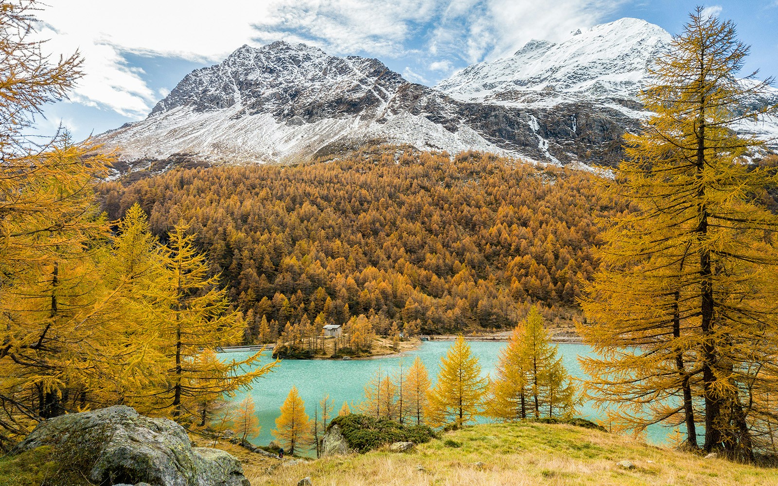 Aerial image by drone over the Palu Lake below Piz Palu glacier in Swiss Alps in autumn day