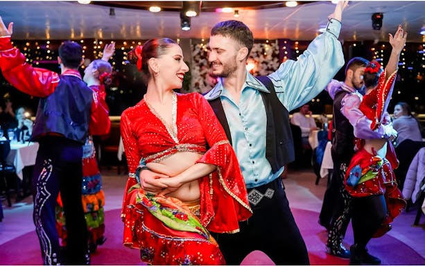 Dancers performing on a Bosphorus night cruise with live entertainment.