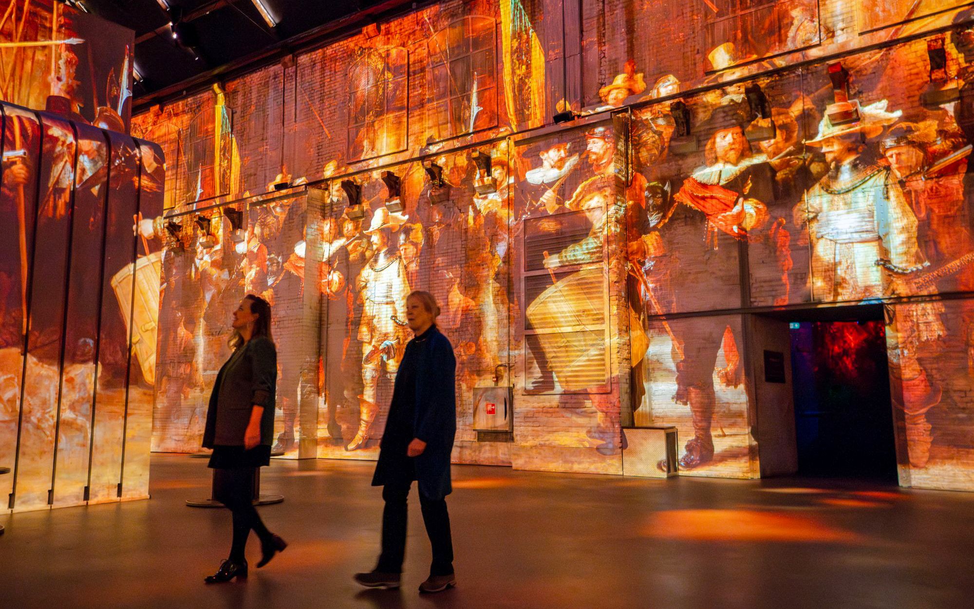 Visitors at Dutch Masters Exhibition, Fabrique des Lumières, viewing immersive art projections.